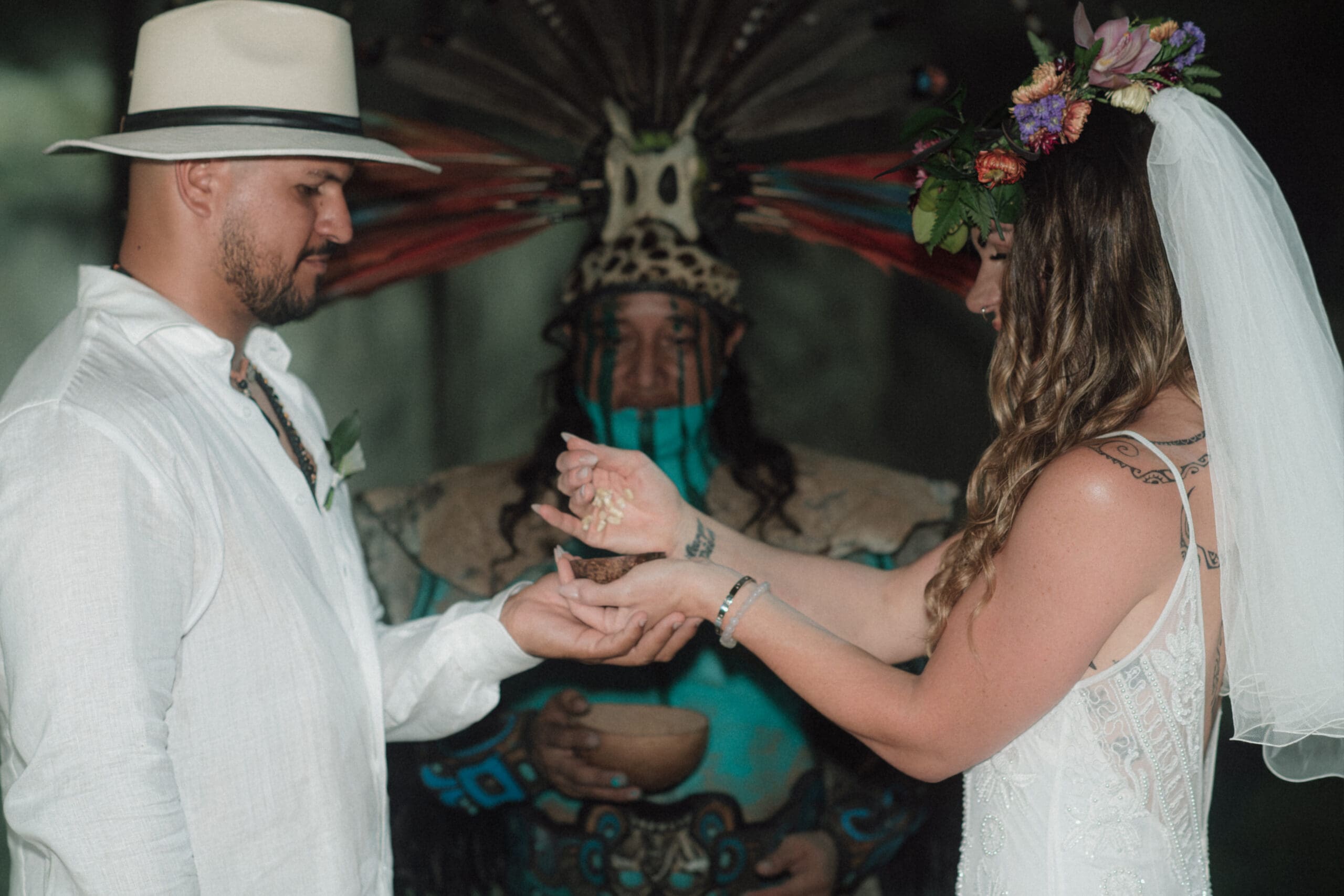 Offerings of corn are made by the bride and groom during a Mayan Elopement Ceremony at Taak Bi Ha Cenote in Tulum.