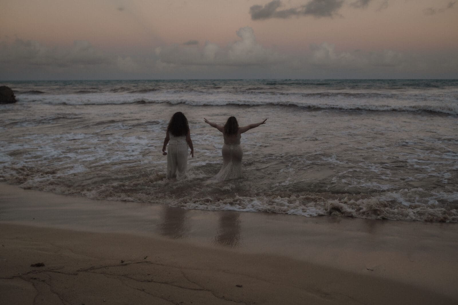 Couple celebrates with the ocean after their Mayan elopement ceremony on the beaches of Tulum.