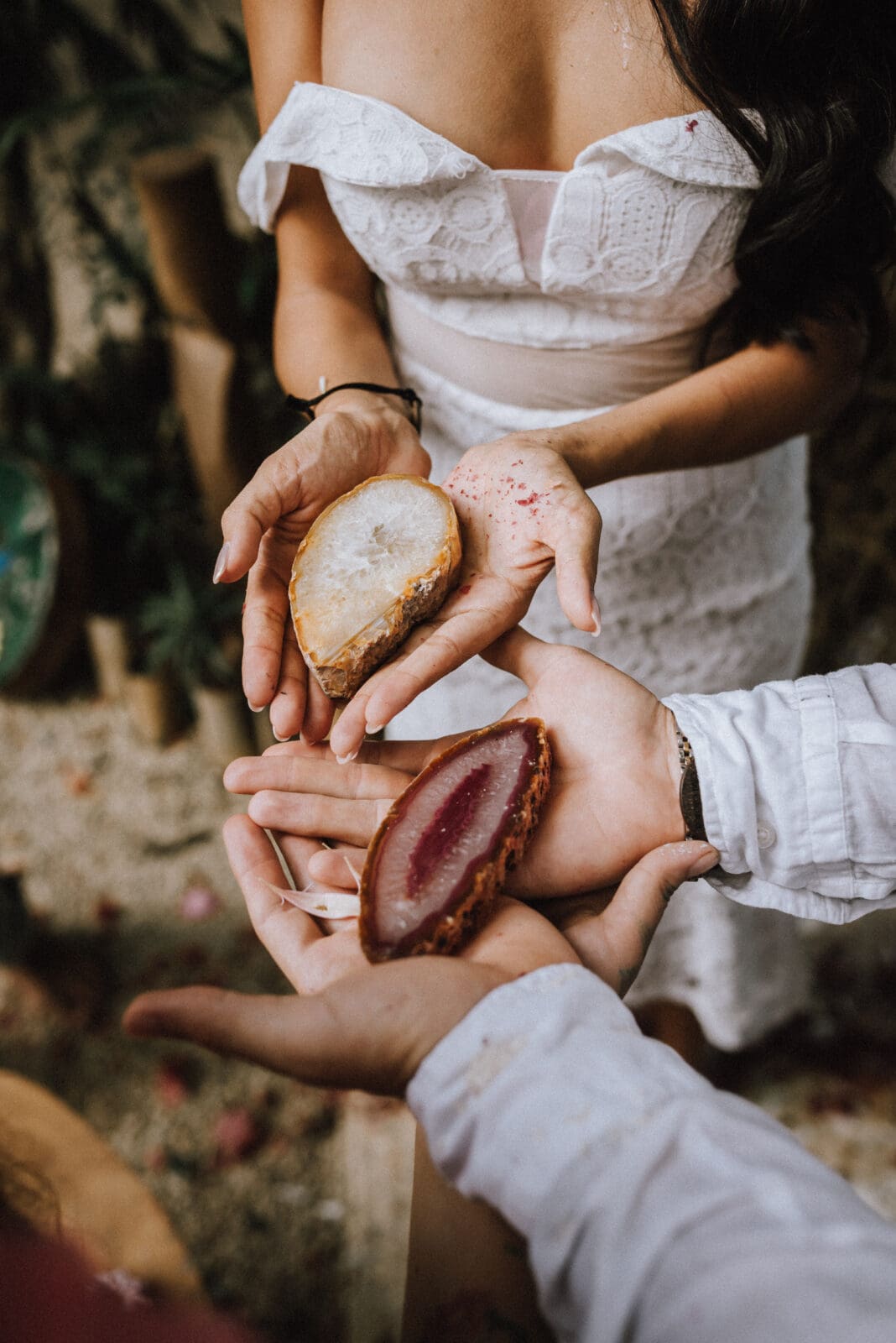 Couple holding ceremonial crystals during a spiritual elopement ceremony in Tulum, Mexico