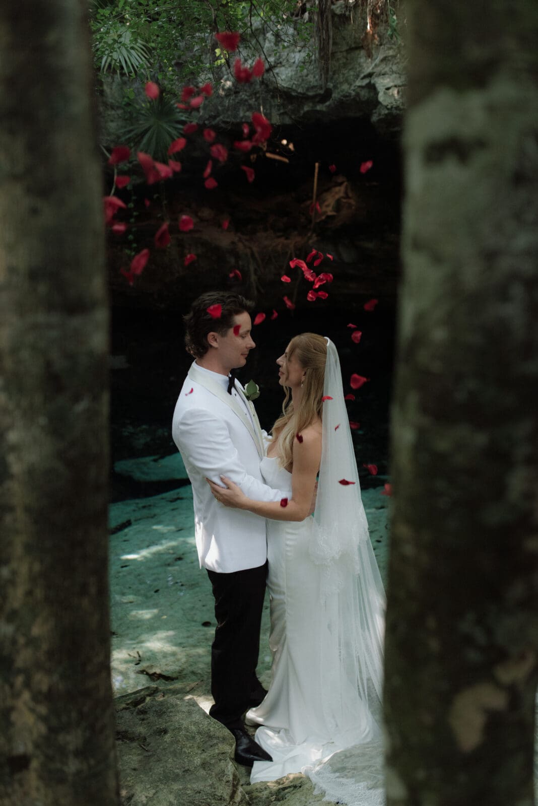 Petals are showered over a couple in celebration during a Mayan elopement ceremony in Tulum.