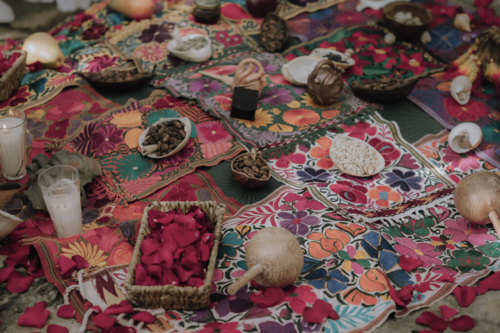 Offerings of seeds, corn, nuts and cacao are laid out on an altar during a Mayan elopement ceremony at a cenote in Tulum.