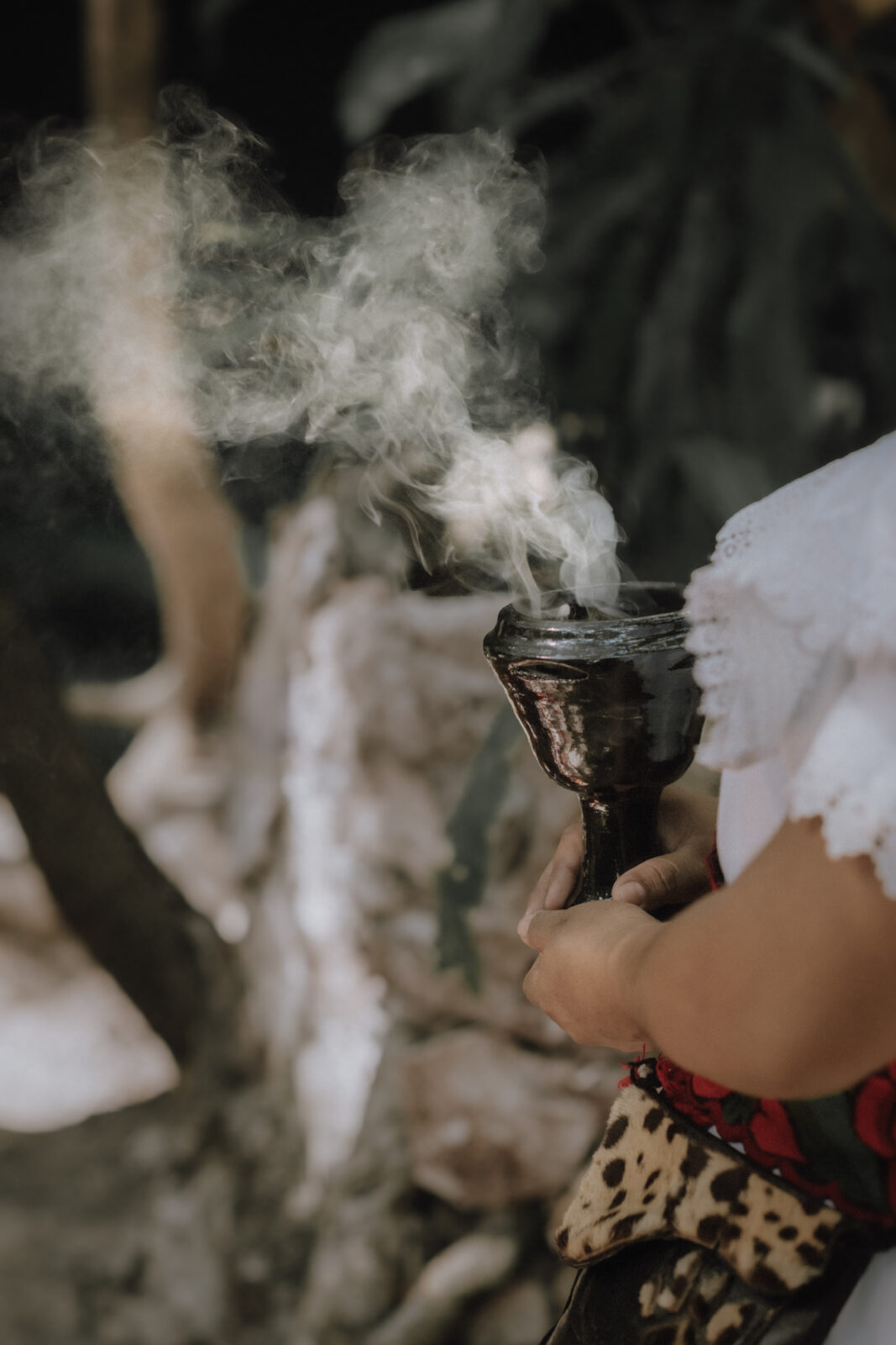 Copal fills the air during a copal cleansing at an elopement ceremony at a cenote in Tulum Mexico.