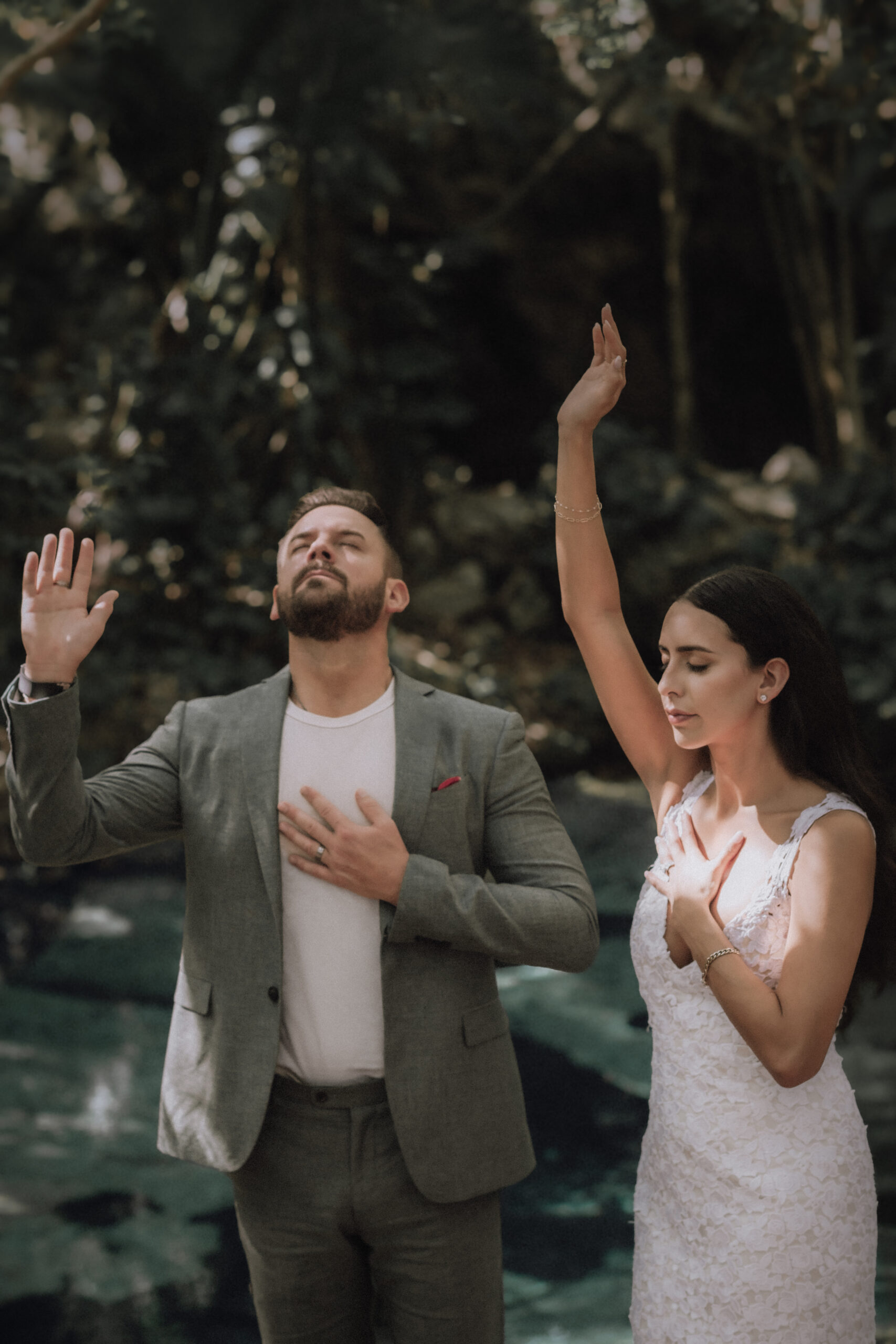 Bride and groom give offerings during a ritual in a Mayan elopement ceremony in Tulum Mexico.