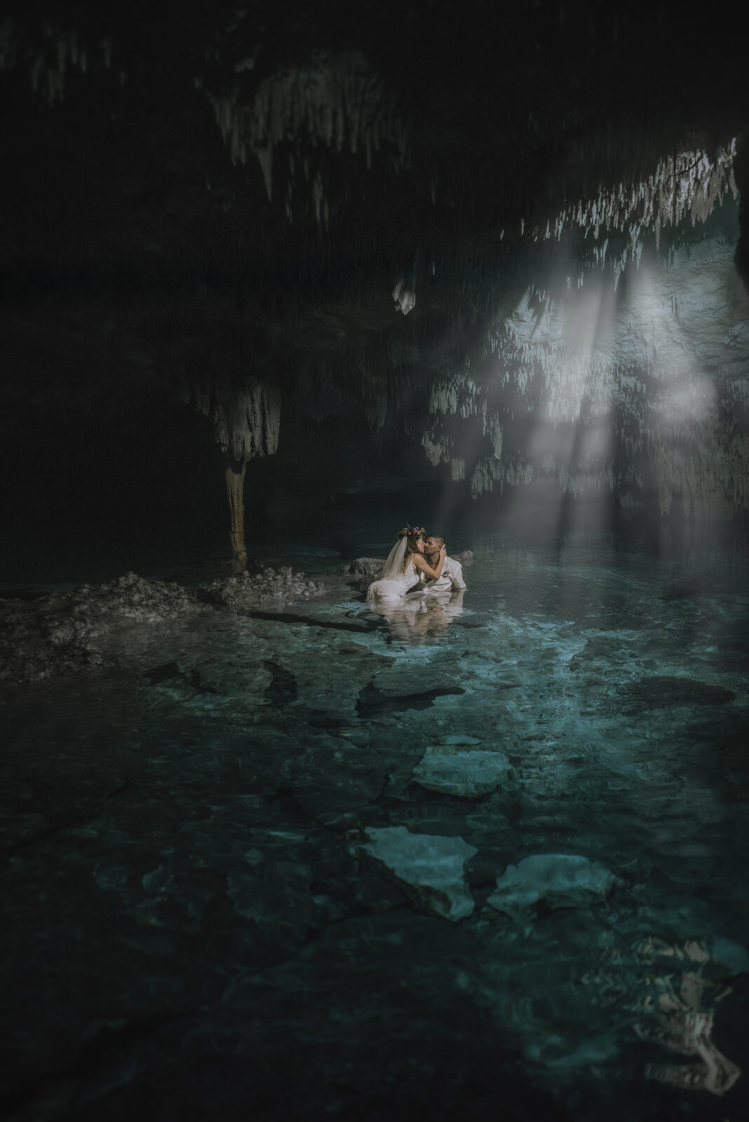 Couple in the water after their spiritual elopement at Cenote Taak Bi Ha in Tulum, Mexico